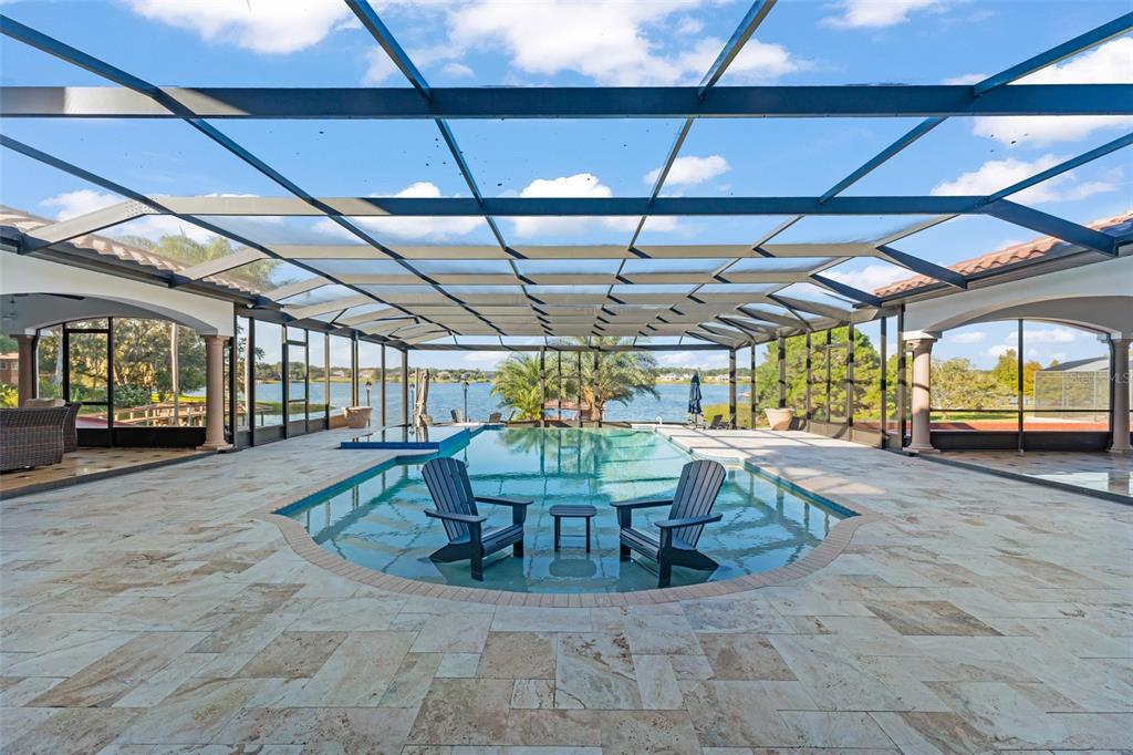 9575 Westover Roberts Road Windermere, FL 34786 - Photo 71 of 95 a view of a patio with a table and chairs
