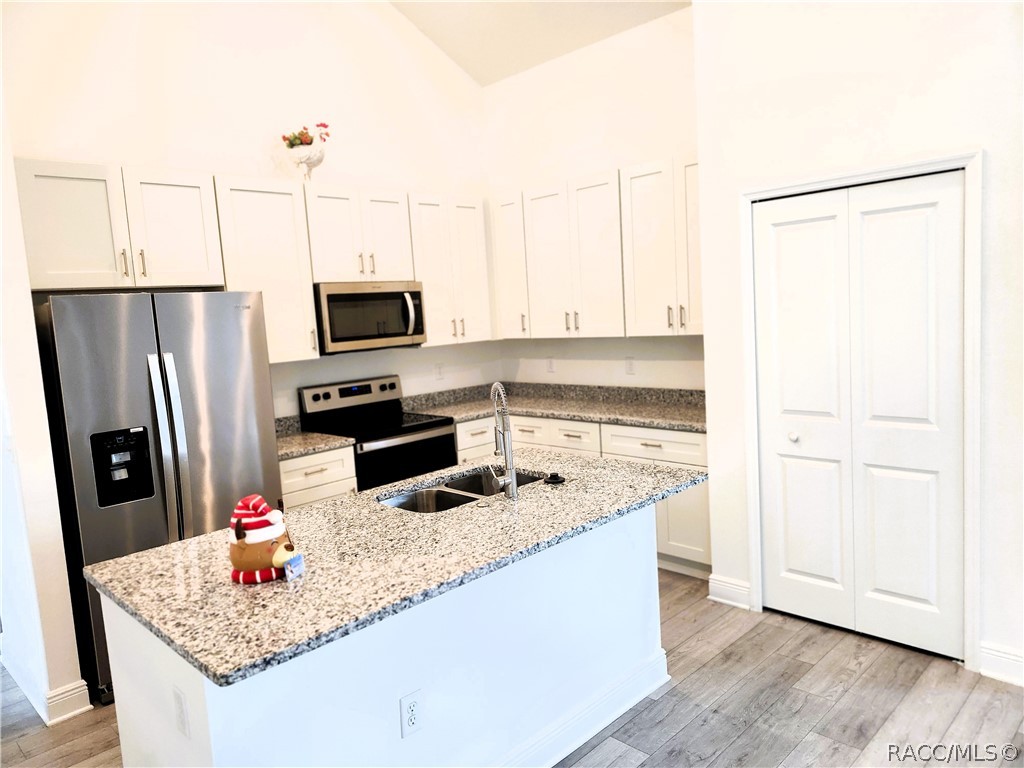2800 Southwest 139th Street Ocala, FL 34473 - Photo 7 of 16 a kitchen with stainless steel appliances granite countertop a sink refrigerator and microwave