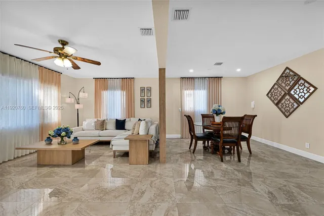 a kitchen with stainless steel appliances granite countertop a refrigerator a stove a sink and dishwasher with wooden floor