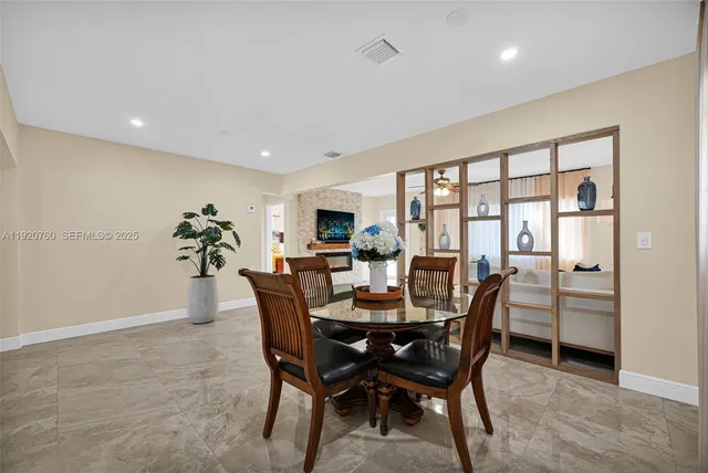 a view of a kitchen center island and stainless steel appliances