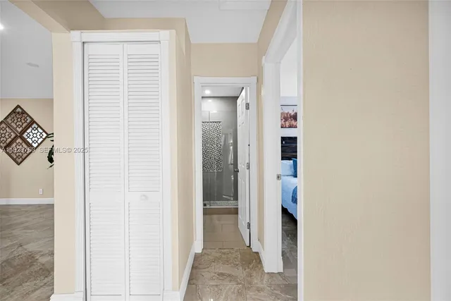 a view of a house with pool and chairs under an umbrella