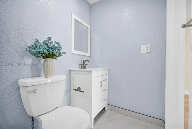 a bathroom with a sink vanity and tub