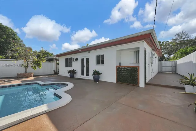 an aerial view of residential houses with outdoor space and ocean view