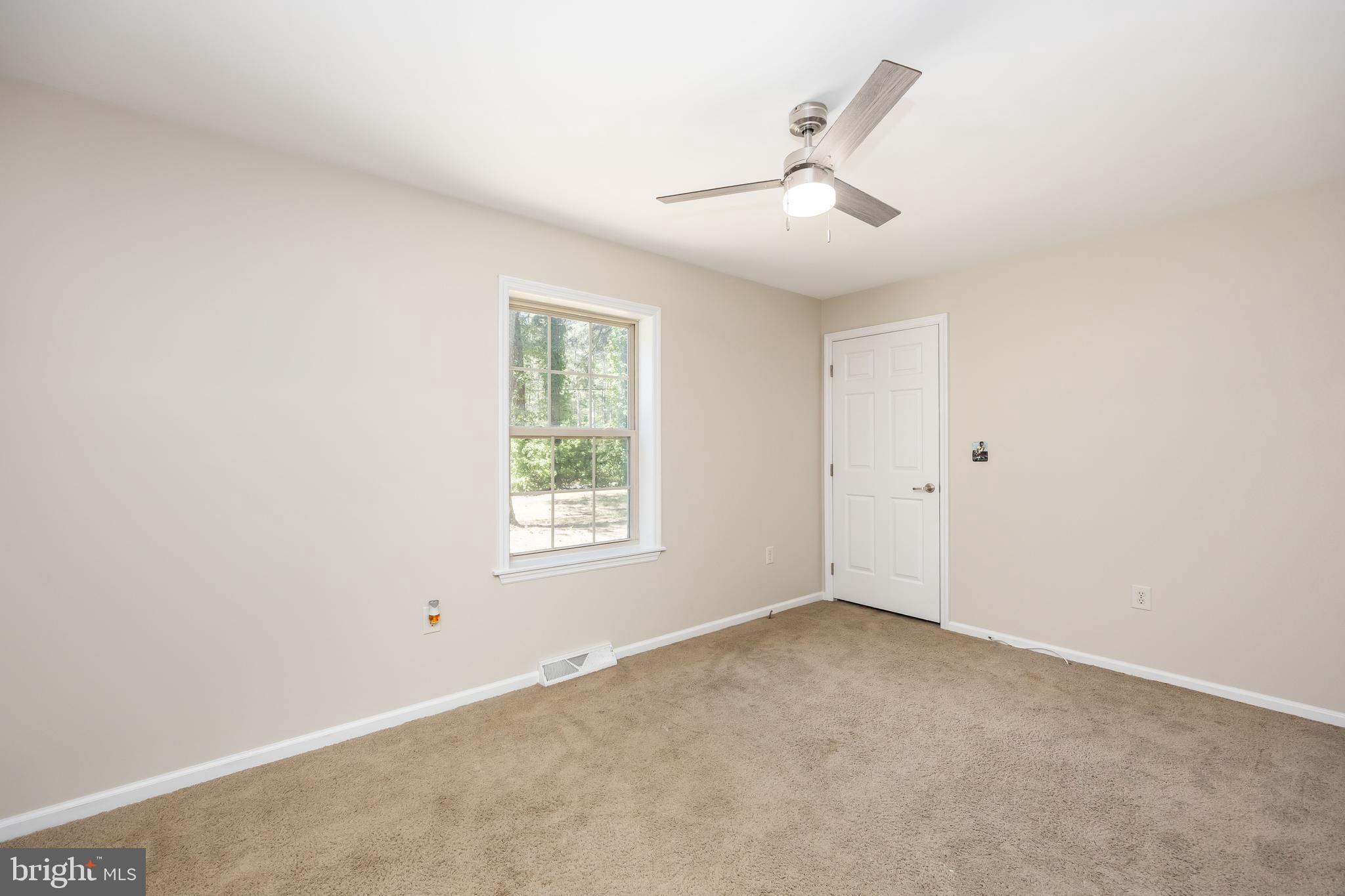 6635 Libertytown Road Berlin, MD 21811 - Photo 42 of 88 an empty room with ceiling fan and window
