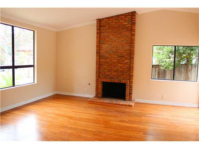1030 Woodcreek Road Fallbrook, CA 92028 - Photo 3 of 7 High ceilings, crown and base mouldings, wood laminate flooring, brick fireplace and hearth.