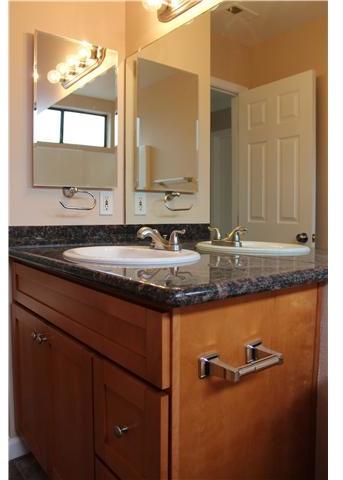1030 Woodcreek Road Fallbrook, CA 92028 - Photo 4 of 7 Wood vanity with granite slab counter top. Fresh paint, newer fixtures, tile flooring, etc.