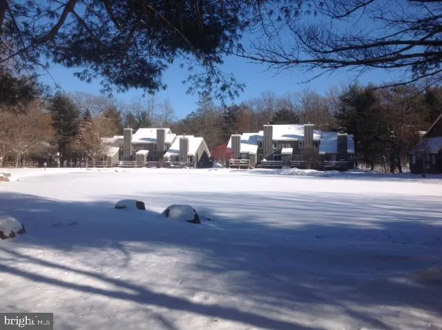 a kitchen with stainless steel appliances granite countertop a sink a stove and chairs with wooden floor