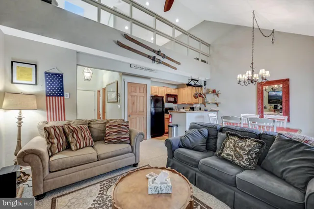 a living room with furniture and a chandelier