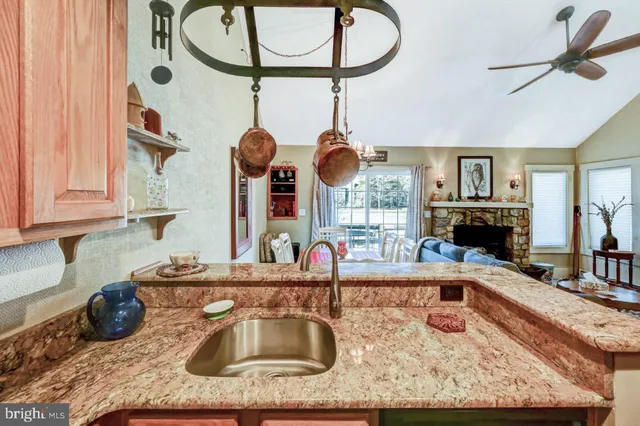 a kitchen with stainless steel appliances granite countertop a refrigerator and a stove