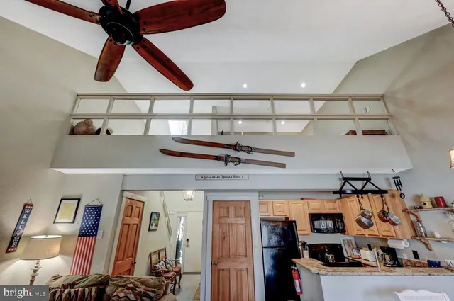 a view of staircase with lots of frames on wall and a chandelier