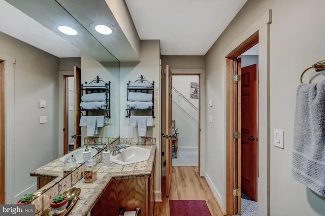 a living room with furniture and a ceiling fan