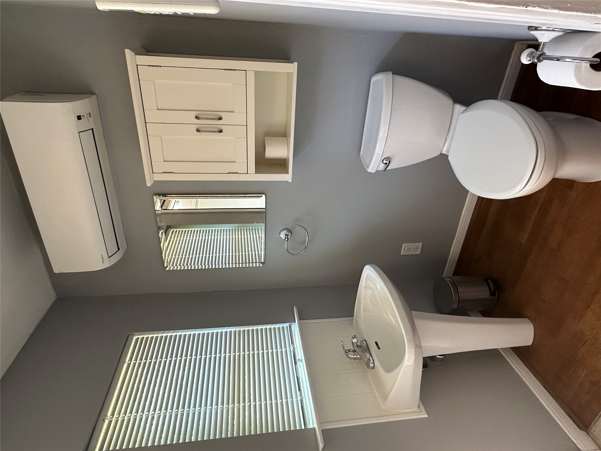 1041 Rosemont Street Austin, TX 78723 - Photo 11 of 13 a bathroom with a toilet a sink and a window