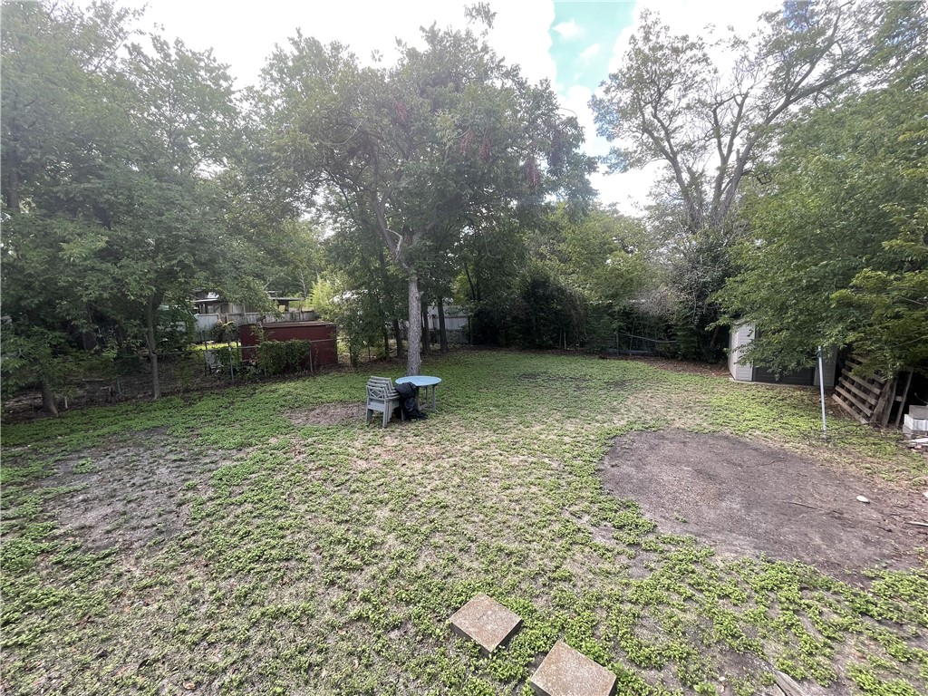 1041 Rosemont Street Austin, TX 78723 - Photo 12 of 13 a view of a backyard with a trees