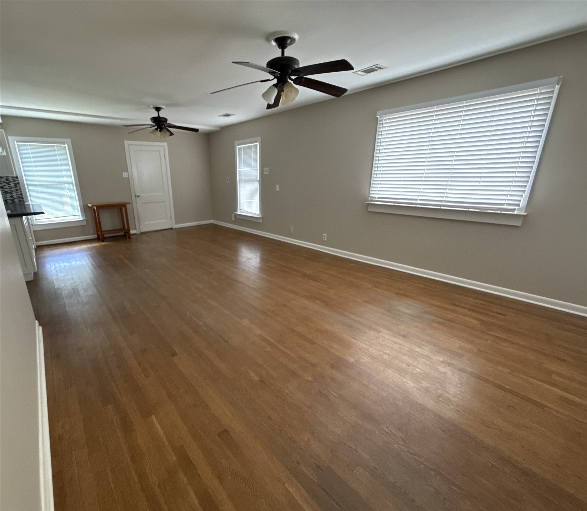 1041 Rosemont Street Austin, TX 78723 - Photo 3 of 13 a view of empty room with wooden floor and fan