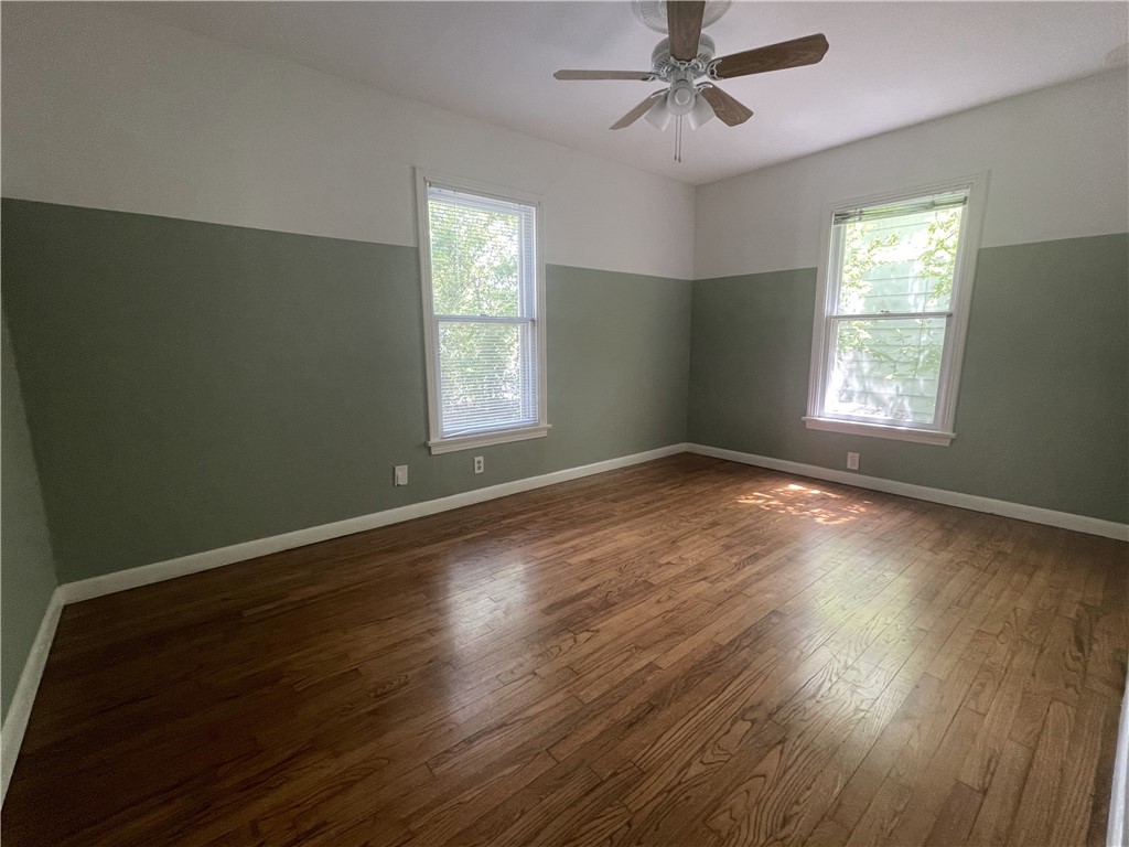 1041 Rosemont Street Austin, TX 78723 - Photo 6 of 13 a view of an empty room with wooden floor and a window