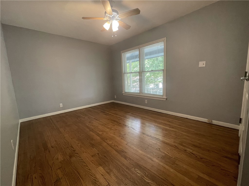 1041 Rosemont Street Austin, TX 78723 - Photo 7 of 13 an empty room with wooden floor and windows