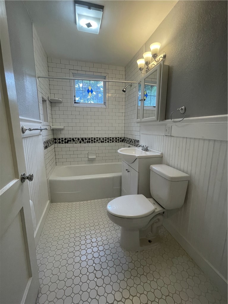 1041 Rosemont Street Austin, TX 78723 - Photo 8 of 13 a bathroom with a toilet a sink and bathtub