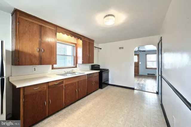 a large kitchen with a sink and dishwasher with a large window
