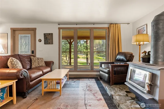 a living room with stainless steel appliances kitchen island granite countertop furniture and a kitchen view
