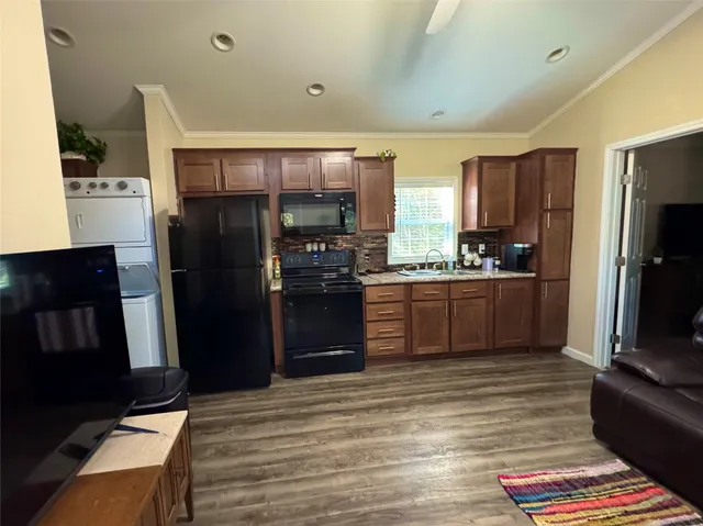 a bedroom with furniture and a flat screen tv