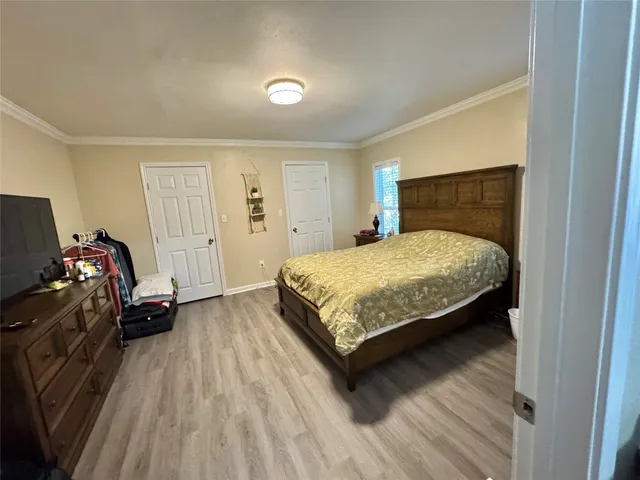 a spacious bedroom with a bed and a mirror