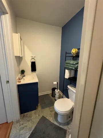 a bed room with bed and a chair