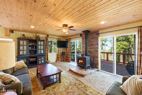 a living room with furniture large window and flat screen tv