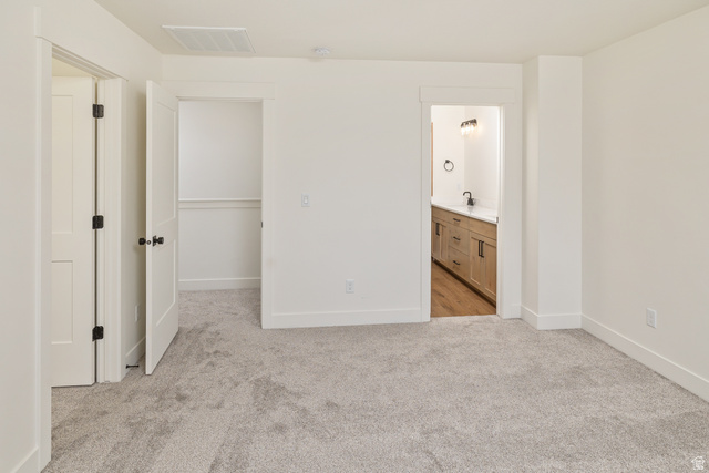 612 North 400 West Logan, UT 84321 - Photo 21 of 27 Spacious room with light gray carpeting, white walls, and white trim