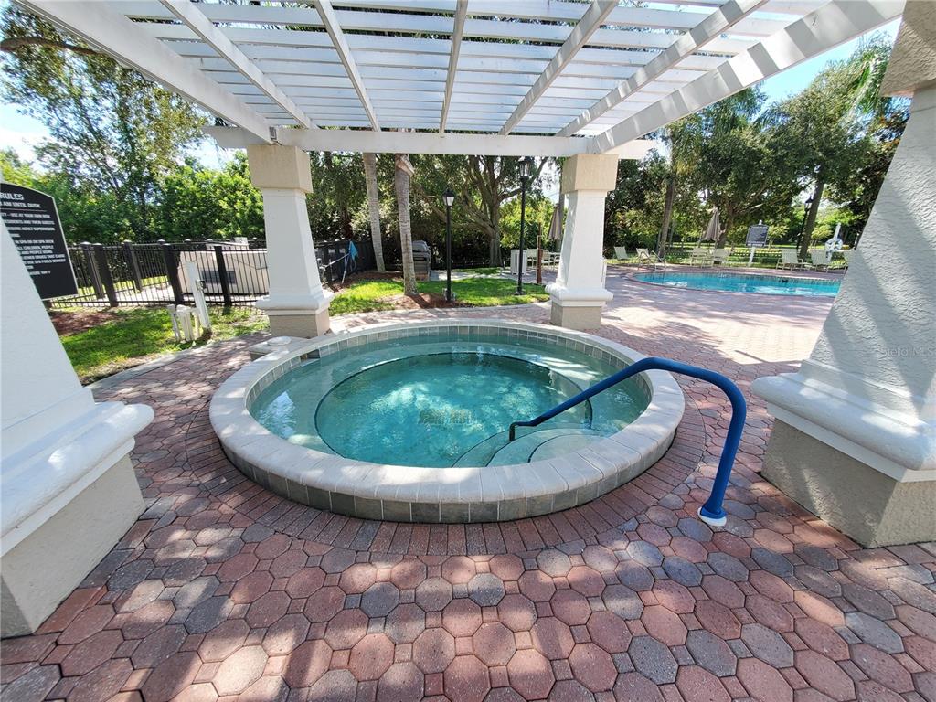 5174 Northridge Road, Unit 209 Sarasota, FL 34238 - Photo 21 of 25 a view of a swimming pool with a sitting space