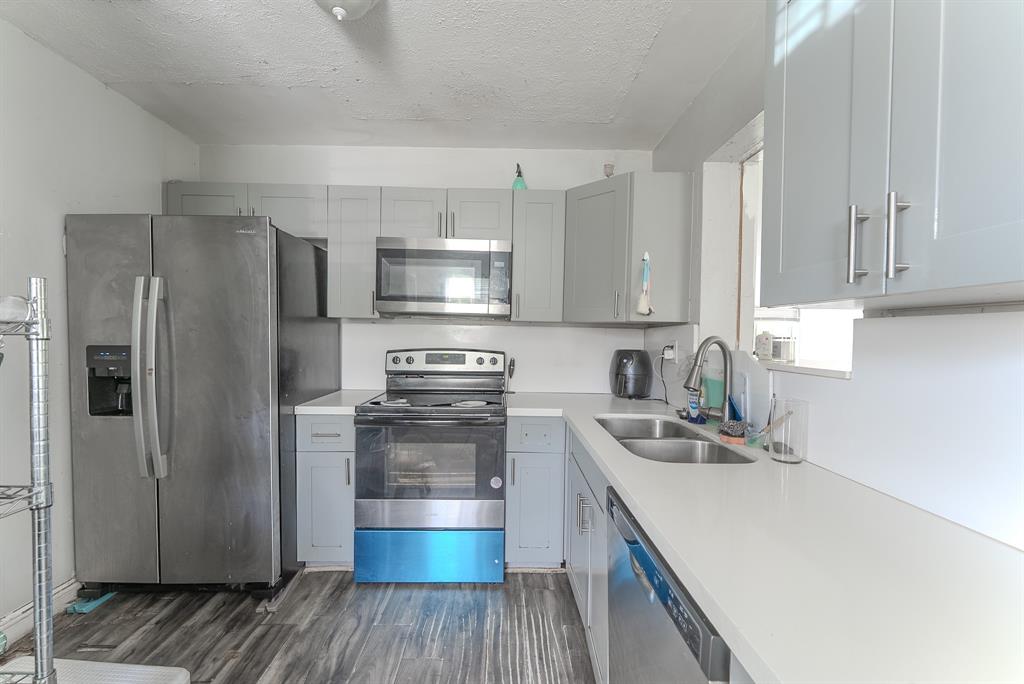 2011 Southwest 97th Terrace Miramar, FL 33025 - Photo 15 of 27 a kitchen with a refrigerator stove and wooden cabinets