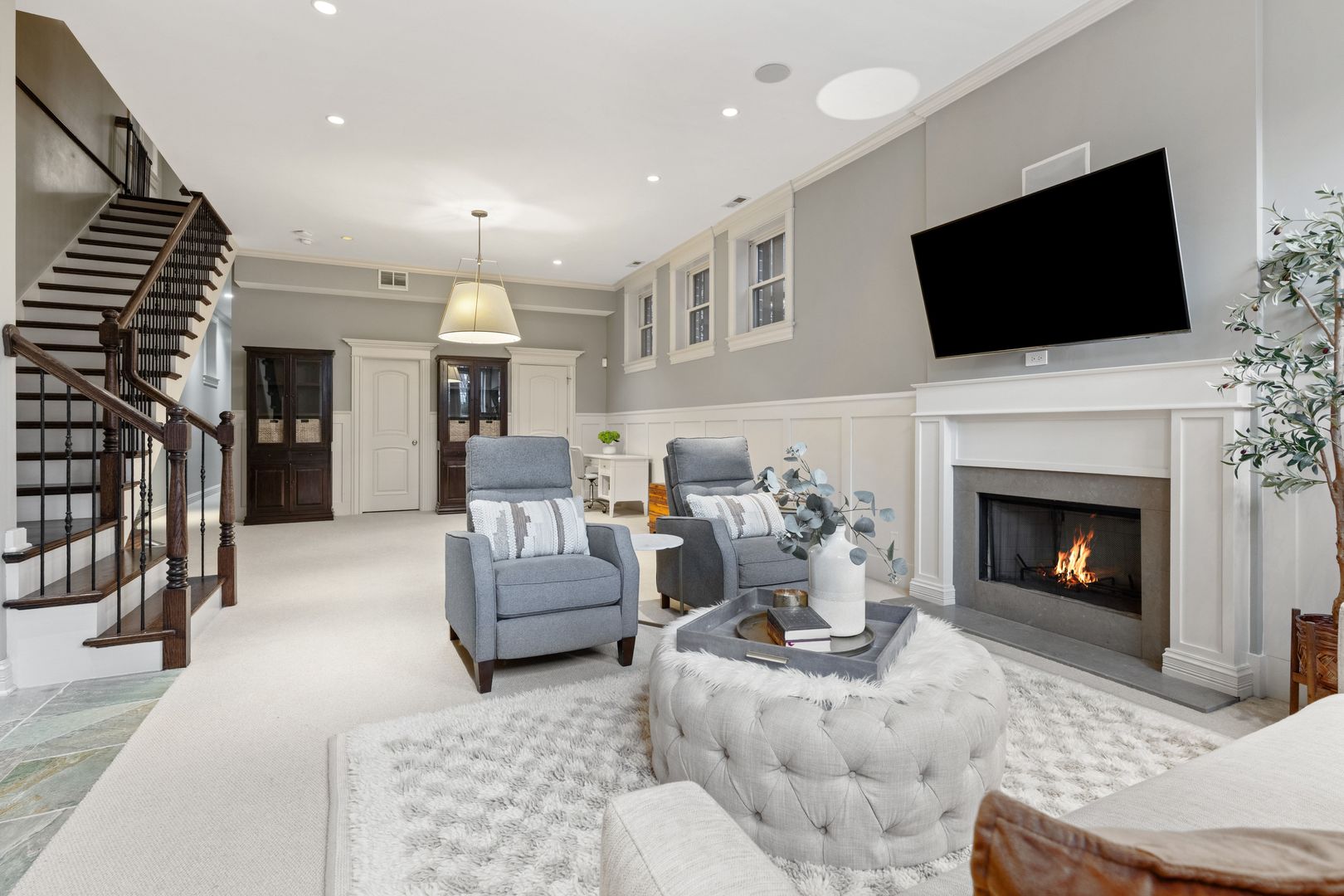 1410 West Byron Street Chicago, IL 60613 - Photo 27 of 40 a living room with furniture a flat screen tv and a fireplace