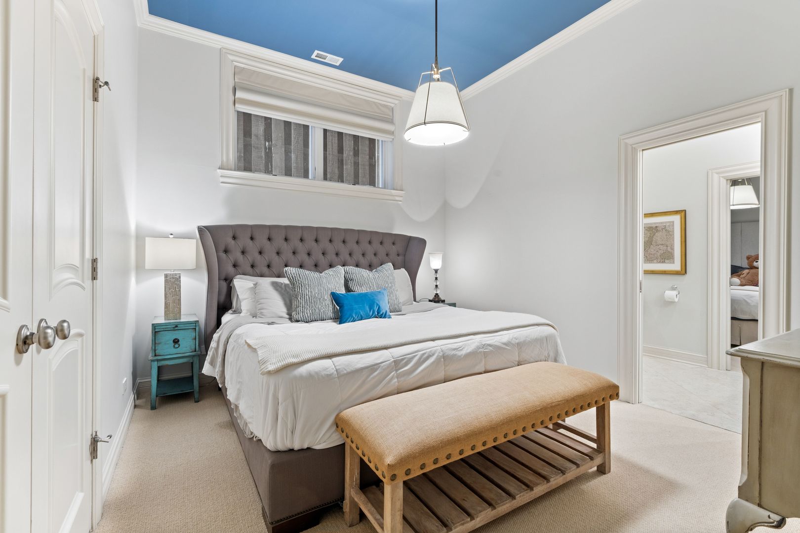 1410 West Byron Street Chicago, IL 60613 - Photo 33 of 40 a bedroom with a bed chandelier and a window
