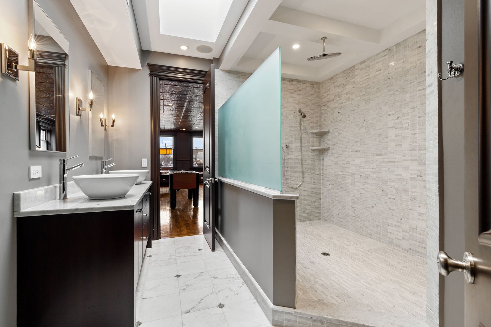 1410 West Byron Street Chicago, IL 60613 - Photo 38 of 40 a bathroom with a bathtub shower sink vanity and mirror