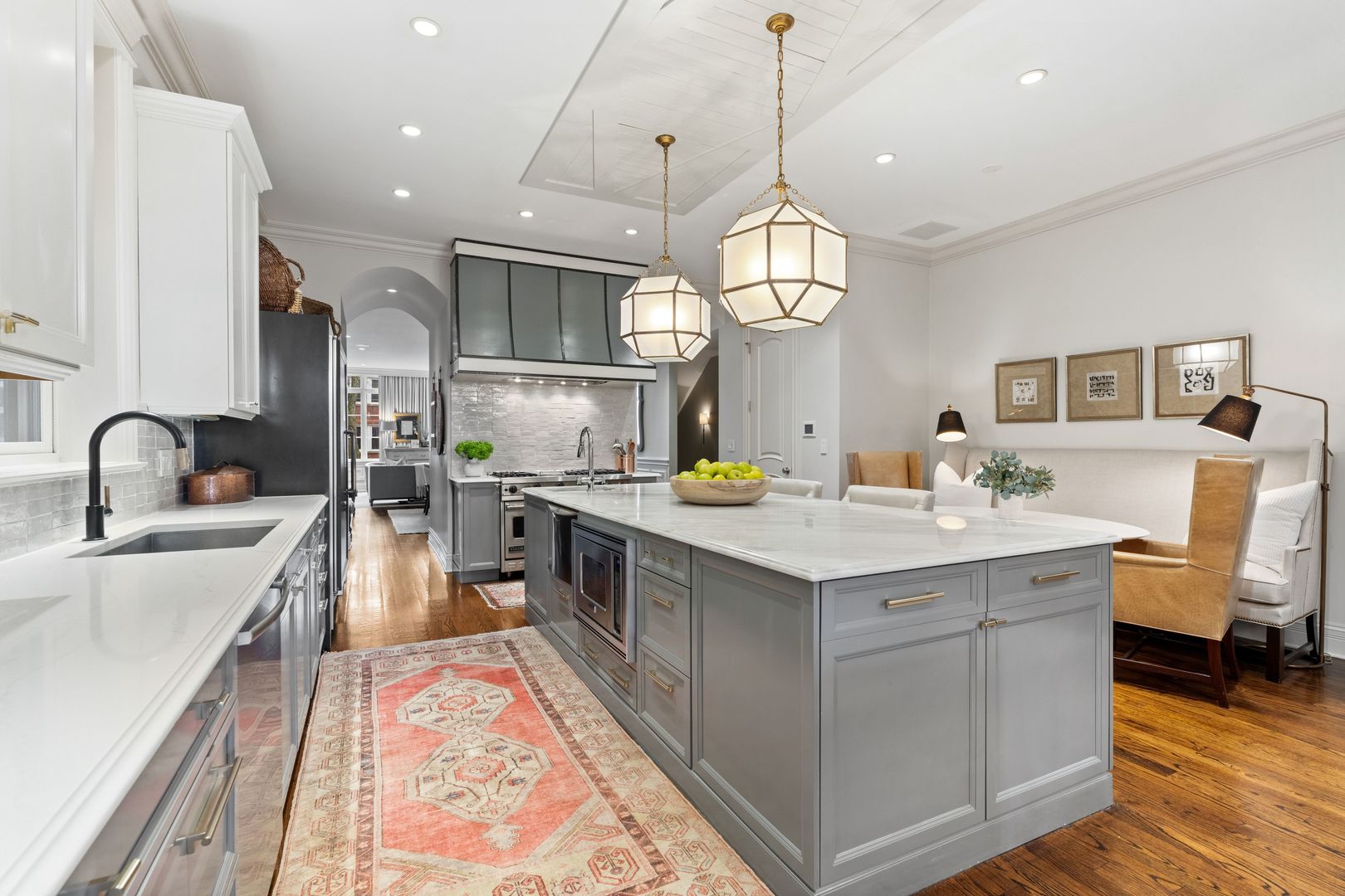 1410 West Byron Street Chicago, IL 60613 - Photo 8 of 40 a large kitchen with kitchen island a stove a sink a center island and furniture