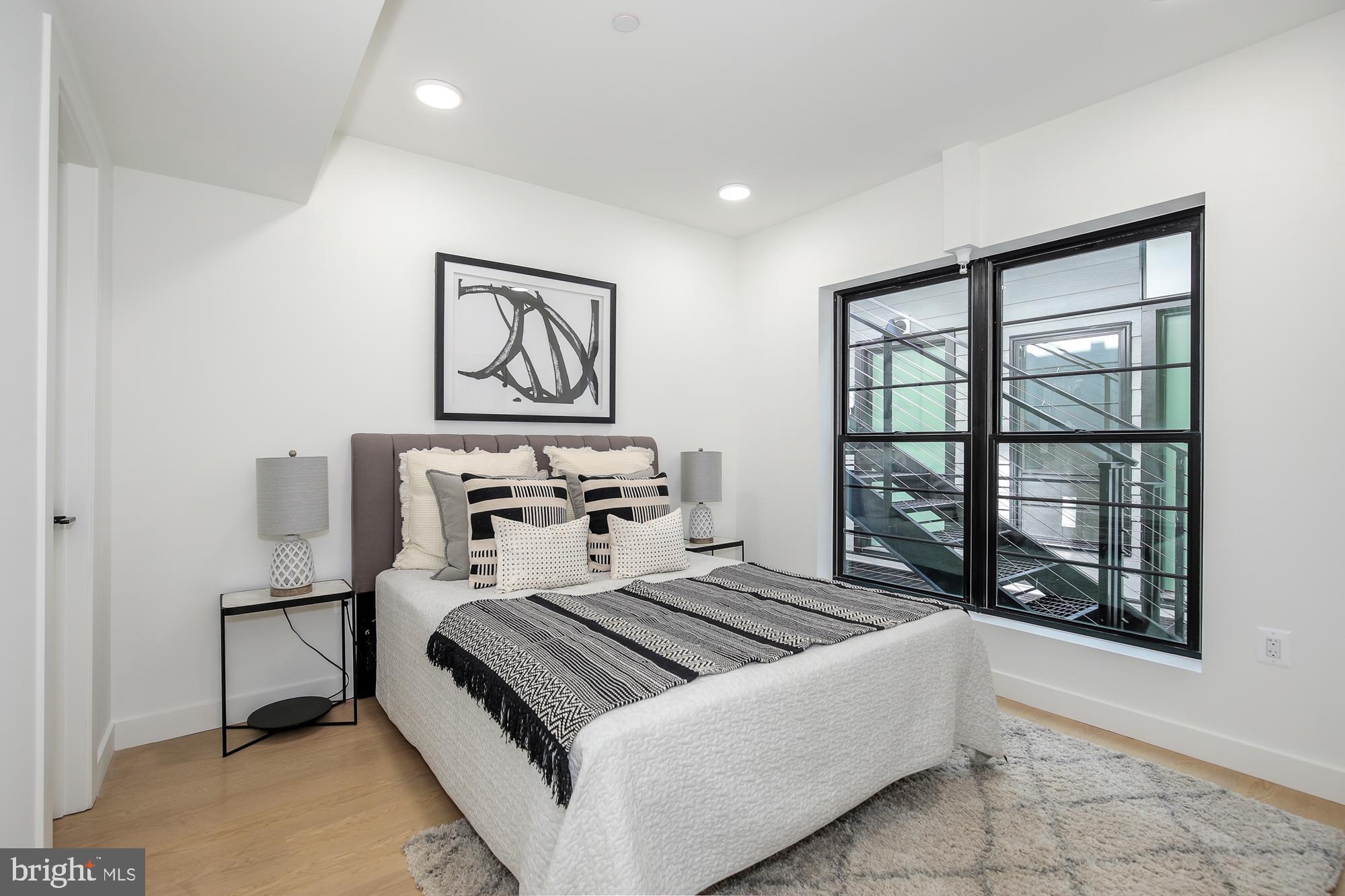 304 Florida Avenue Northwest, Unit 1 Washington, DC 20001 - Photo 13 of 26 a bedroom with a bed and a window