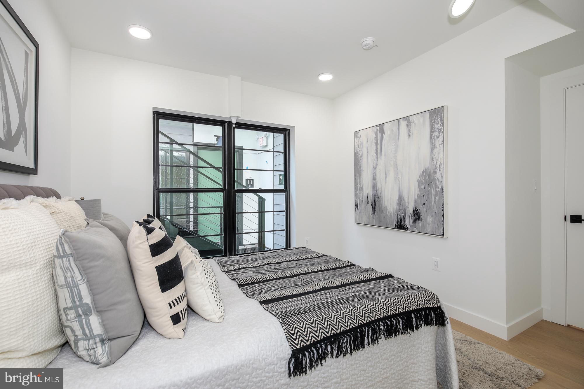 304 Florida Avenue Northwest, Unit 1 Washington, DC 20001 - Photo 14 of 26 a bedroom with a bed and wooden floor