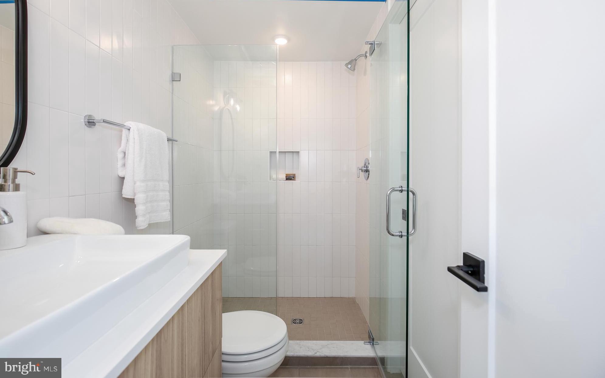 304 Florida Avenue Northwest, Unit 1 Washington, DC 20001 - Photo 16 of 26 a bathroom with a sink a toilet and shower