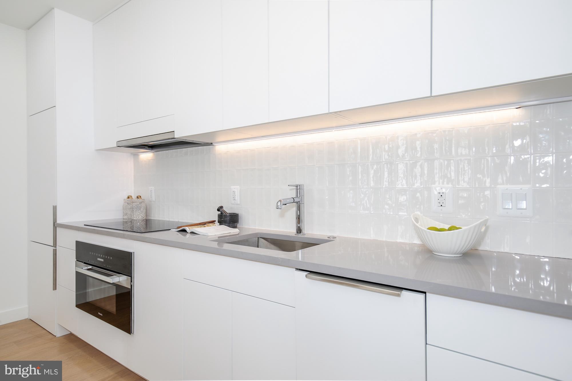 304 Florida Avenue Northwest, Unit 1 Washington, DC 20001 - Photo 9 of 26 a kitchen with a sink and a stove top oven