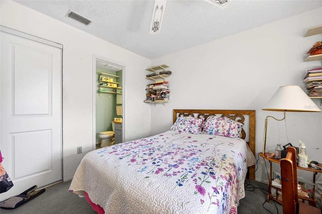 464 Coronado Road Venice, FL 34293 - Photo 12 of 28 a bedroom with a bed and a chandelier