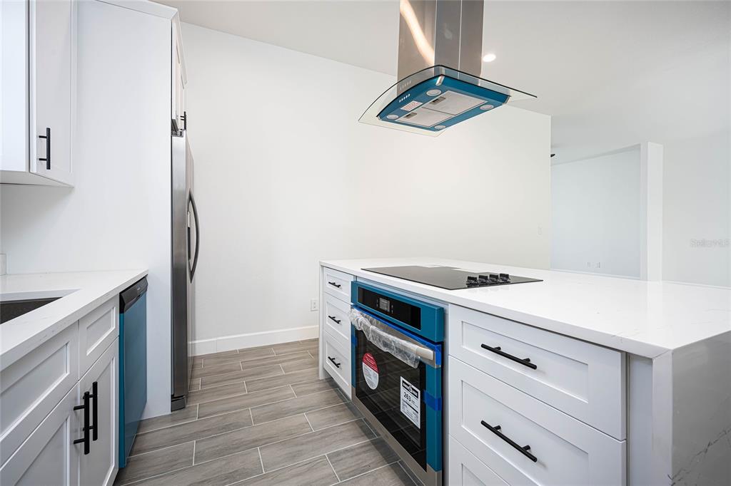 183 Sesame Road East Rotonda West, FL 33947 - Photo 16 of 59 a kitchen with a stove and a refrigerator