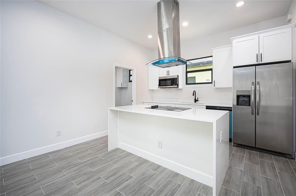 183 Sesame Road East Rotonda West, FL 33947 - Photo 18 of 59 a kitchen with a sink stainless steel appliances and cabinets