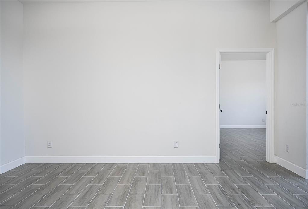 183 Sesame Road East Rotonda West, FL 33947 - Photo 19 of 59 a view of an empty room with wooden floor