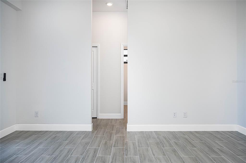 183 Sesame Road East Rotonda West, FL 33947 - Photo 20 of 59 a view of an empty room with wooden floor