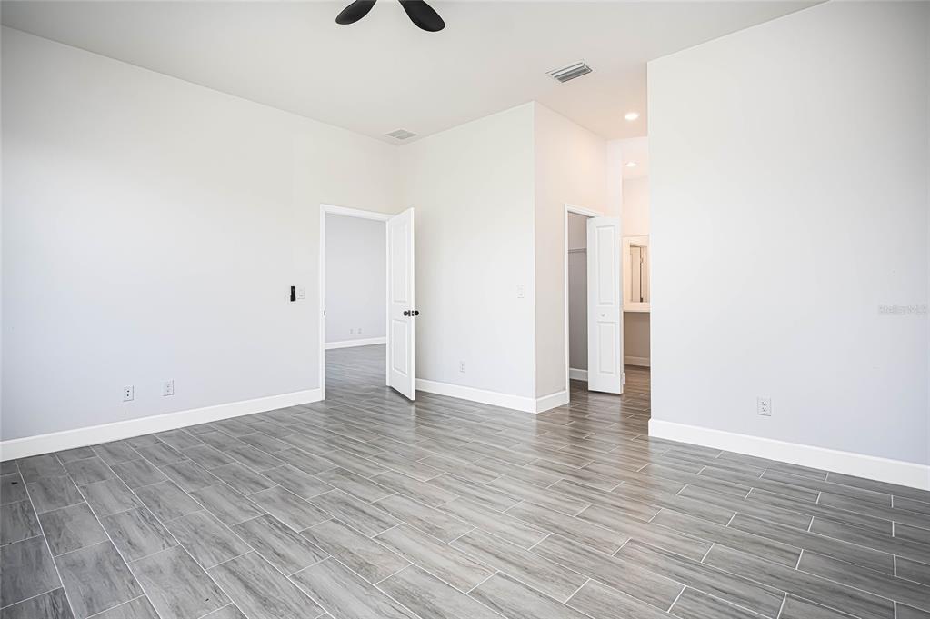 183 Sesame Road East Rotonda West, FL 33947 - Photo 22 of 59 a view of an empty room with wooden floor