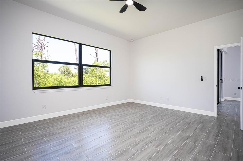 183 Sesame Road East Rotonda West, FL 33947 - Photo 23 of 59 wooden floor in an empty room with a window
