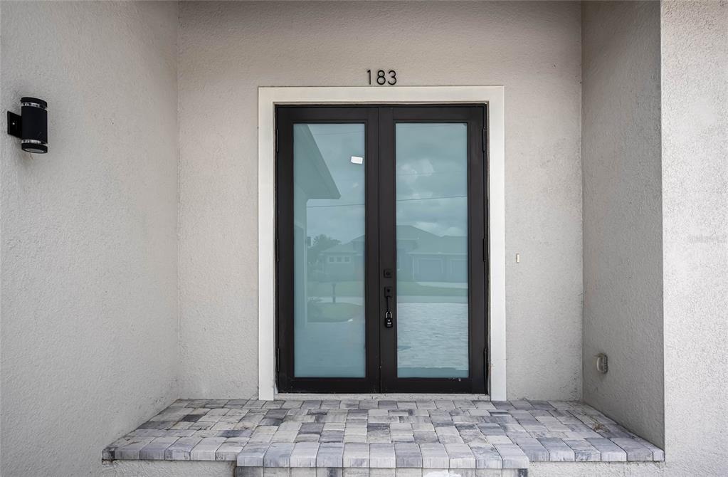 183 Sesame Road East Rotonda West, FL 33947 - Photo 3 of 59 a view of a hallway with wooden floor and a bathroom