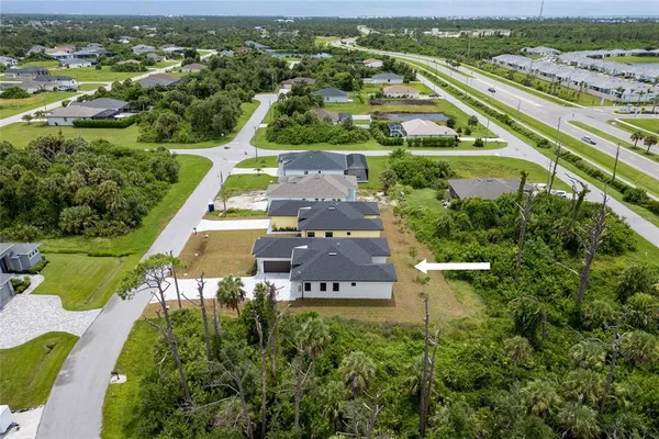 an aerial view of a residential houses with outdoor space and river