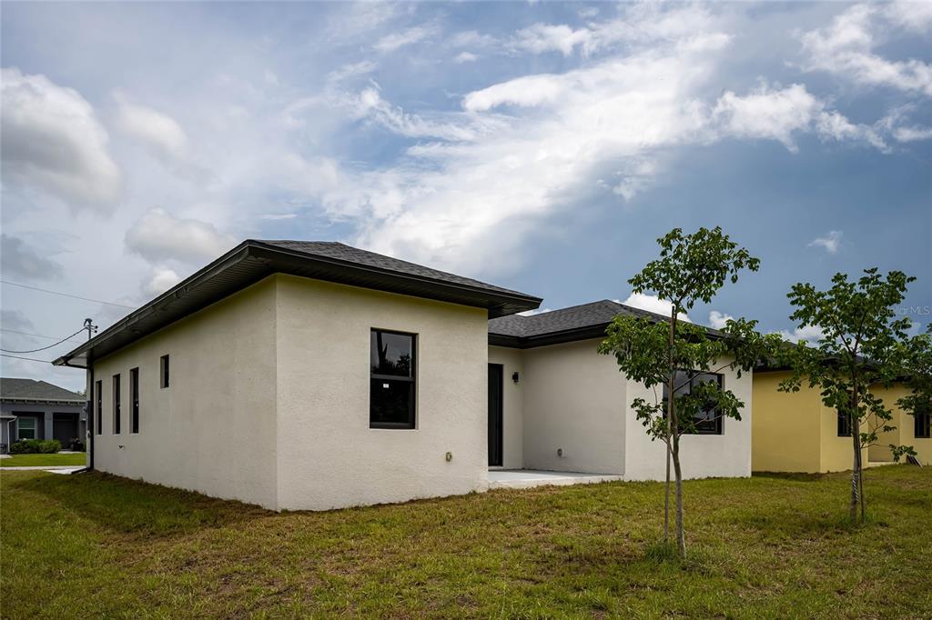 183 Sesame Road East Rotonda West, FL 33947 - Photo 56 of 59 a house with trees in the background