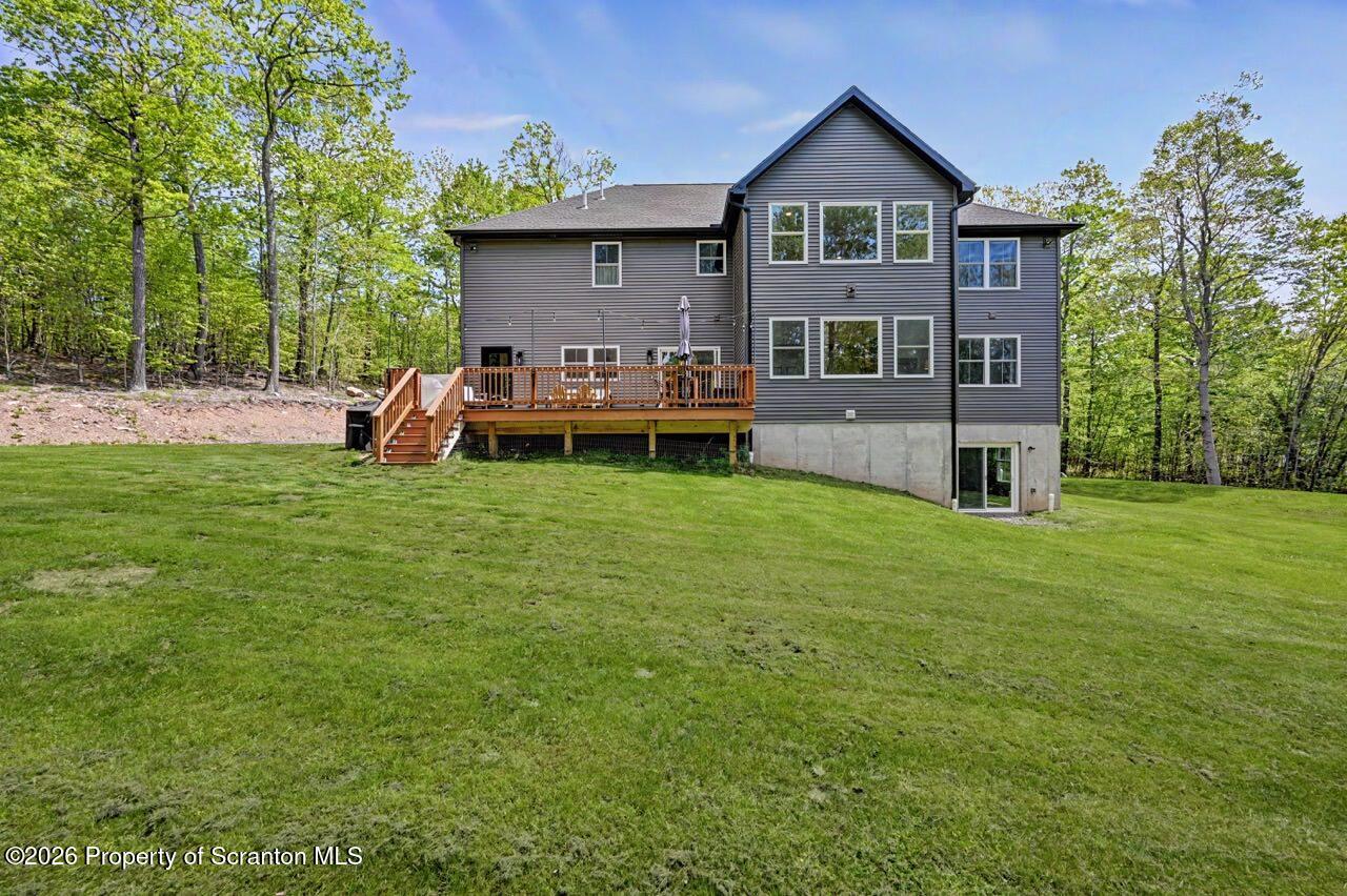 100 Highland Road Moscow, PA 18444 - Photo 6 of 85 a view of a house with a big yard and large trees