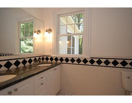 42 Nickerson Road Newton, MA 02467 - Photo 12 of 28 a bathroom with a granite countertop sink a mirror and a shower